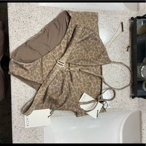 New acacia with tags never worn. Size MD echo bottoms and size LG lawai top.